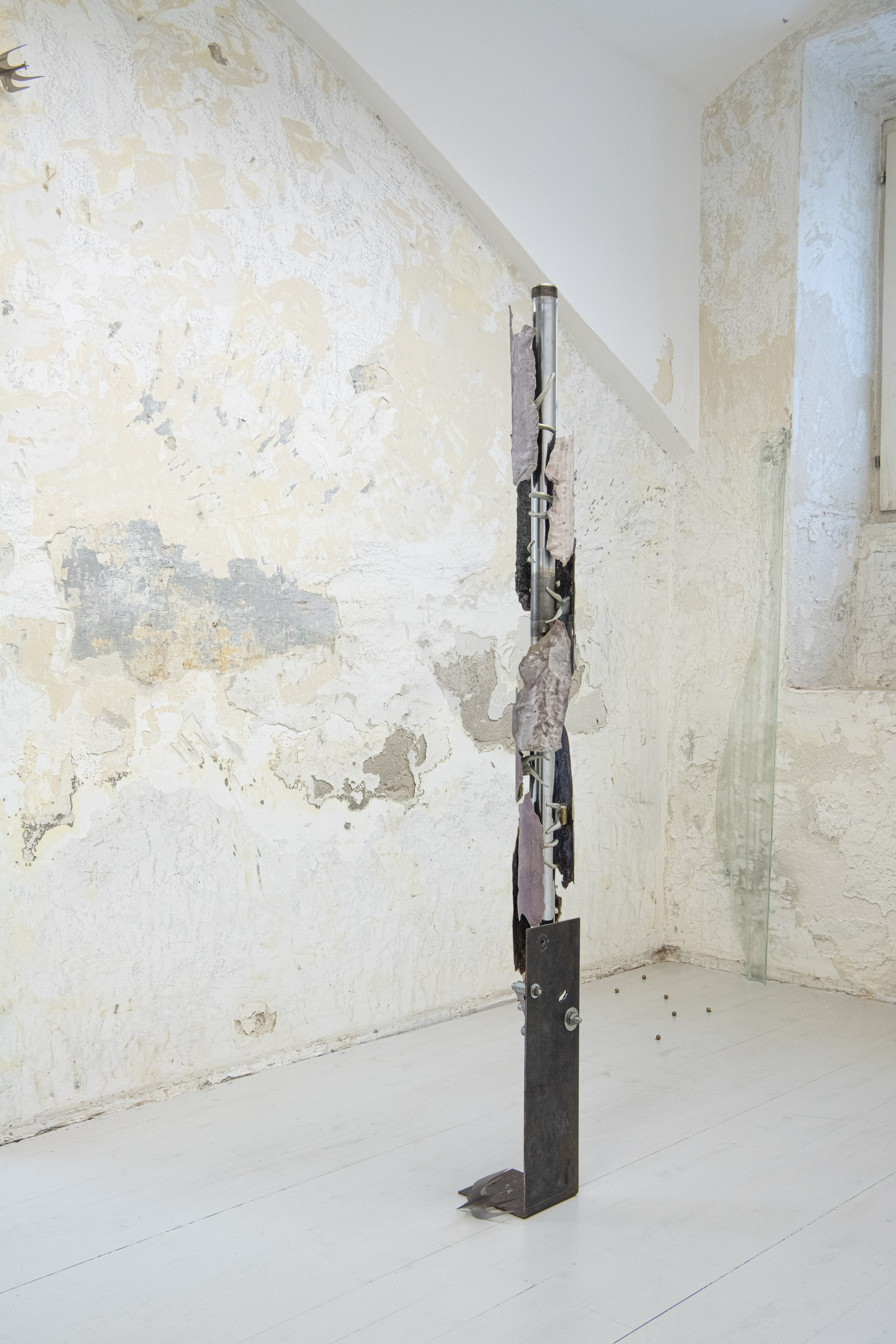 Installation view, René Stiegler, 'Anxiety Rash', Fork stanchions, Steel, PLA, Epoxy, Wax, Plaster, 140 x 21 x 21 cm, 2023, Ömer Faruk Kaplan, 'Skins', Floatglas, 160 x 19.5 x 4 cm, 2025, Yixuan Hu, 'ever migrate, ever escape', (“而你心中的鸟群，时时要迁徙，时时要逃避”), Plastic, Compass, 10 x 7 x 7 cm, 11 x 7.7 x 7.7 cm, 2025